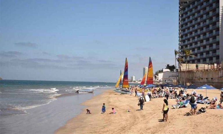 Con tapabocas reabren playas del sur estadunidense